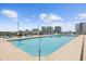 Modern rooftop pool with lounge chairs and clear city views in the background on a sunny day at 150 E Robinson St # 2506, Orlando, FL 32801