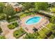 An aerial view of the community pool with lounge chairs, cabanas, landscaping, and community homes at 107 Vista Verdi Cir # 121, Lake Mary, FL 32746