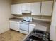 Functional kitchen area boasts white cabinetry, laminate countertops, and essential appliances at 107 Vista Verdi Cir # 121, Lake Mary, FL 32746