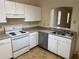 Functional kitchen features white cabinets and essential appliances with plenty of counter space at 107 Vista Verdi Cir # 121, Lake Mary, FL 32746