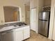 Modern kitchen showcases stainless steel refrigerator and essential appliances with a pass-through window at 107 Vista Verdi Cir # 121, Lake Mary, FL 32746