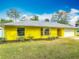 Charming yellow single-story home featuring a well-maintained lawn and a two-car garage at 110 Riverside Ter, Edgewater, FL 32141