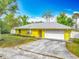 Bright yellow home with a well-manicured lawn and a welcoming entrance at 110 Riverside Ter, Edgewater, FL 32141