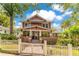 Beautiful home featuring a brick foundation, manicured lawn, and a charming white picket fence at 117 N Thornton Ave, Orlando, FL 32801