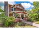 Charming two-story home features a brick walkway, lush landscaping, and a welcoming front porch at 117 N Thornton Ave, Orlando, FL 32801