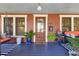 Charming front porch boasts a decorative glass door, comfortable seating and a stylish blue tiled floor at 117 N Thornton Ave, Orlando, FL 32801