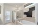 This bathroom offers a soaking tub, glass-enclosed shower and pool view at 15980 Cape Coral Loop, Clermont, FL 34714