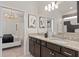 Bathroom vanity with granite countertops, dual sinks and modern fixtures at 15980 Cape Coral Loop, Clermont, FL 34714