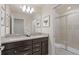 Modern bathroom features a double vanity with granite countertops, and glass shower at 15980 Cape Coral Loop, Clermont, FL 34714