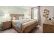 Neutral bedroom featuring wallpaper accent wall, warm textiles and modern decor at 15980 Cape Coral Loop, Clermont, FL 34714