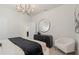 This bedroom showcases a round mirror over a dresser, accented by a chair at 15980 Cape Coral Loop, Clermont, FL 34714