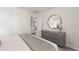 Cozy bedroom showcasing a dresser with round mirror and neutral decor at 15980 Cape Coral Loop, Clermont, FL 34714