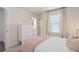 Bright bedroom with a pink-themed bed and stylish decor elements at 15980 Cape Coral Loop, Clermont, FL 34714