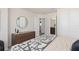 Bedroom showcasing a modern dresser, decor, a glimpse of a connected bathroom, and neutral walls at 15980 Cape Coral Loop, Clermont, FL 34714