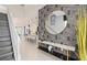 Stylish entryway with decorative wallpaper, modern console table, and open view into the kitchen and dining area at 15980 Cape Coral Loop, Clermont, FL 34714