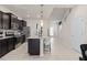 Bright kitchen showcasing stainless steel appliances, granite countertops, a breakfast bar, and an open layout at 15980 Cape Coral Loop, Clermont, FL 34714