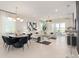 Bright and airy living room with a modern chandelier, comfortable seating, and large sliding glass doors at 15980 Cape Coral Loop, Clermont, FL 34714