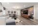 Spacious living room with movie decor, gray sectional, and hardwood floors at 15980 Cape Coral Loop, Clermont, FL 34714