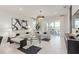 Bright living room with modern decor, plush seating, stylish rug, and a sliding glass door to outdoor space at 15980 Cape Coral Loop, Clermont, FL 34714