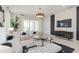 Stylish living room featuring contemporary furnishings, a modern entertainment center, and a large sliding glass door at 15980 Cape Coral Loop, Clermont, FL 34714