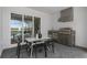 Outdoor kitchen with a stainless steel grill, sink, and covered dining space next to a relaxing pool area at 15980 Cape Coral Loop, Clermont, FL 34714
