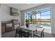 Covered outdoor kitchen features a stainless steel grill, a sink, and an outdoor dining area with a view of the pool at 15980 Cape Coral Loop, Clermont, FL 34714
