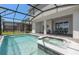 Screened pool area with a built-in spa, and access to an outdoor kitchen and covered seating area at 15980 Cape Coral Loop, Clermont, FL 34714