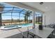 Screened-in pool area includes a spa and a view of the lush landscape and neighboring properties at 15980 Cape Coral Loop, Clermont, FL 34714