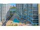 Overhead view showcasing a stunning pool and spa area, surrounded by high-rise buildings and a serene lake at 322 E Central Blvd # 1008, Orlando, FL 32801
