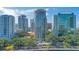 Aerial view showcasing the building amidst a vibrant cityscape with lush greenery and surrounding structures at 322 E Central Blvd # 1008, Orlando, FL 32801