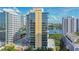 A modern high-rise building boasts floor-to-ceiling windows, offering scenic views of the surrounding cityscape and lake at 322 E Central Blvd # 1008, Orlando, FL 32801