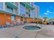 Relaxing hot tub area with lounge chairs, lush plants, and a peaceful ambiance at 322 E Central Blvd # 1008, Orlando, FL 32801