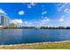 Scenic lake view with a skyline, tranquil blue waters, and a well-kept grassy shoreline on a sunny day at 322 E Central Blvd # 1008, Orlando, FL 32801