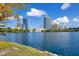Picturesque lake view featuring a skyline, clear blue water, and lush greenery on a beautiful day at 322 E Central Blvd # 1008, Orlando, FL 32801