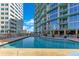 Inviting swimming pool with city views, surrounded by modern architecture, and comfortable loungers at 322 E Central Blvd # 1008, Orlando, FL 32801