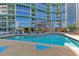 Beautiful in-ground pool area with lots of seating and stunning views of the building's architecture at 322 E Central Blvd # 1008, Orlando, FL 32801