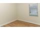 Bedroom with wood floors and a large window for natural light at 3835 Rock Hill Loop, Apopka, FL 32712