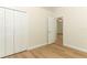Neutral bedroom with wood floors, closet and interior door at 3835 Rock Hill Loop, Apopka, FL 32712