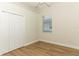 Neutral bedroom with wood floors, a closet and a window at 3835 Rock Hill Loop, Apopka, FL 32712
