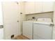 Laundry room with white washer and dryer and built-in cabinets for storage at 3835 Rock Hill Loop, Apopka, FL 32712