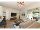 Bright living room with neutral furniture, ceiling fan and access to outdoor patio at 3835 Rock Hill Loop, Apopka, FL 32712