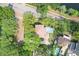 Aerial view of a beautiful home with a private pool, lush landscaping, and a tile roof at 702 S Lake Adair Blvd, Orlando, FL 32804