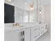 Modern bathroom with dual sink vanity, marble countertops, and pendant lighting at 702 S Lake Adair Blvd, Orlando, FL 32804