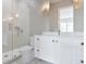 Modern bathroom featuring dual sink vanity, shower, and marble floors at 702 S Lake Adair Blvd, Orlando, FL 32804