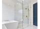 Luxurious bathroom with a glass-enclosed shower and a standalone tub at 702 S Lake Adair Blvd, Orlando, FL 32804