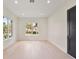 Bright, airy bedroom with large windows and natural light, featuring light wood floors and a dark door at 702 S Lake Adair Blvd, Orlando, FL 32804
