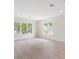 Bright bedroom featuring large windows and hardwood floors at 702 S Lake Adair Blvd, Orlando, FL 32804