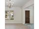 Bright foyer featuring a dark wooden door, marble flooring, and views of the outdoors at 702 S Lake Adair Blvd, Orlando, FL 32804
