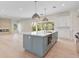 Spacious kitchen with a blue island, stainless steel appliances, and open layout to living area at 702 S Lake Adair Blvd, Orlando, FL 32804