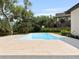 Beautiful backyard featuring a refreshing in-ground pool with stone patio and lush landscaping at 702 S Lake Adair Blvd, Orlando, FL 32804